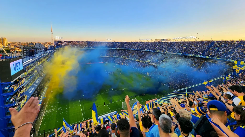 Boca Juniors supporters fill La Bombonera with blue and yellow smoke and flags on matchday in Buenos Aires