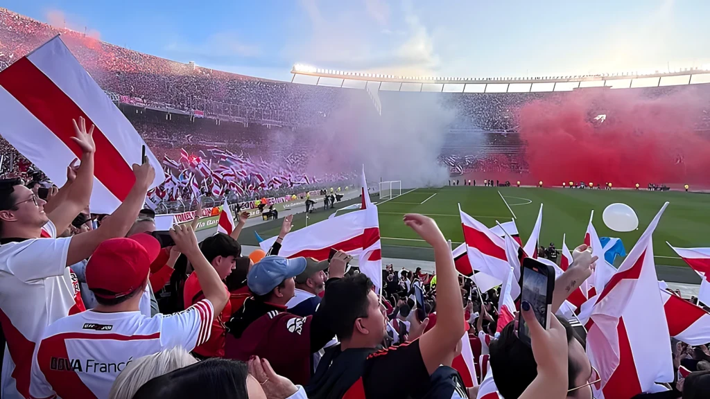 River Plate fans wave red and white flags amid red smoke at the Estadio Monumental in Buenos Aires